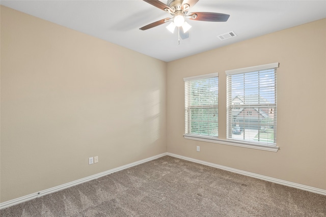 unfurnished room with ceiling fan and light colored carpet