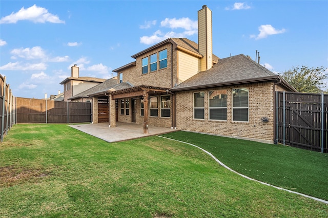 back of property with a patio area and a lawn