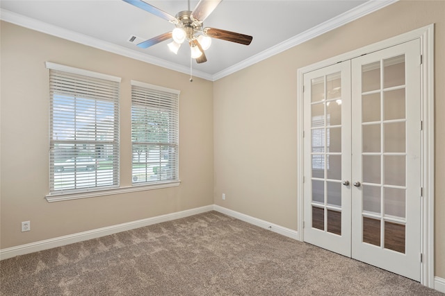 spare room with light carpet, french doors, ceiling fan, and crown molding