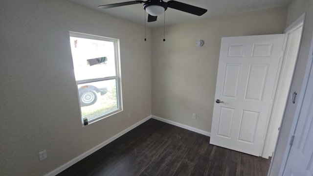 unfurnished bedroom featuring ceiling fan, baseboards, and dark wood-style flooring