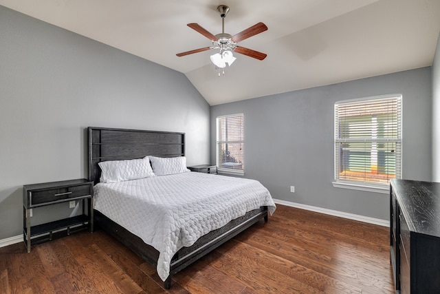 bedroom featuring ceiling fan, dark hardwood / wood-style flooring, lofted ceiling, and connected bathroom