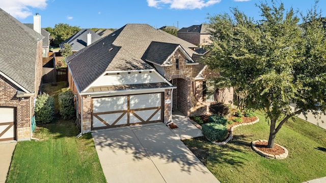 view of front of property with a front yard and a garage