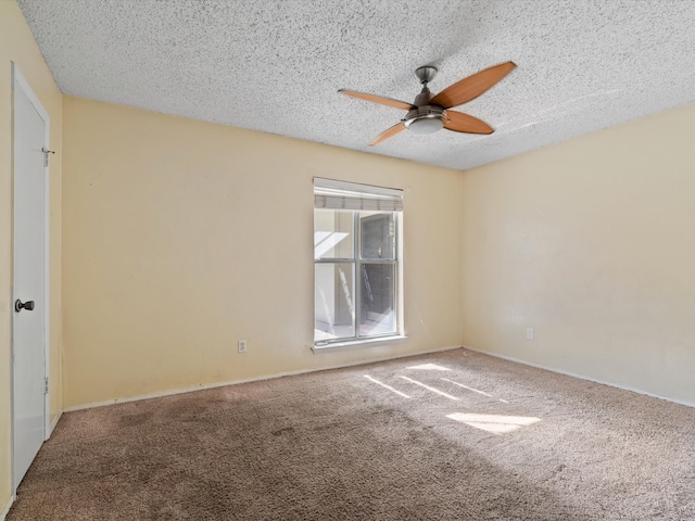 carpeted empty room featuring a textured ceiling and ceiling fan