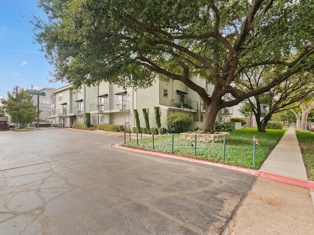 exterior space with a front yard and a balcony