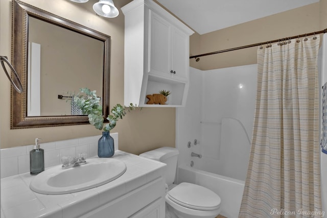 full bathroom featuring toilet, decorative backsplash, shower / bath combo with shower curtain, and vanity