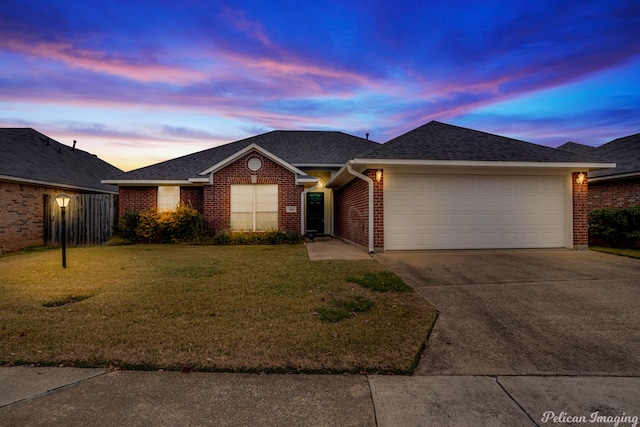 ranch-style house with a garage and a lawn