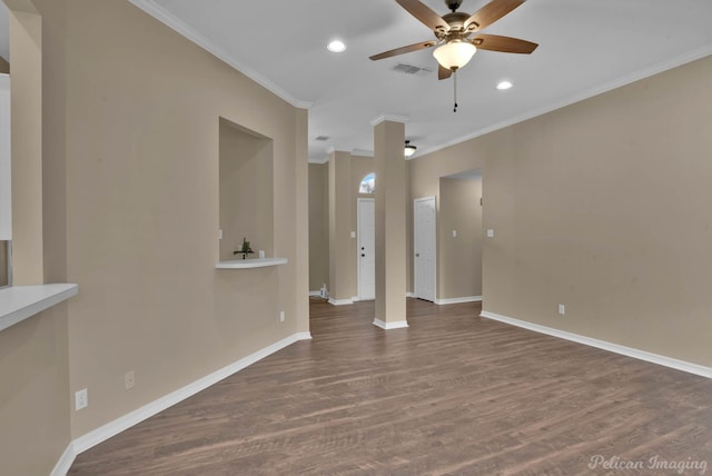 spare room with dark wood-type flooring, crown molding, and ceiling fan