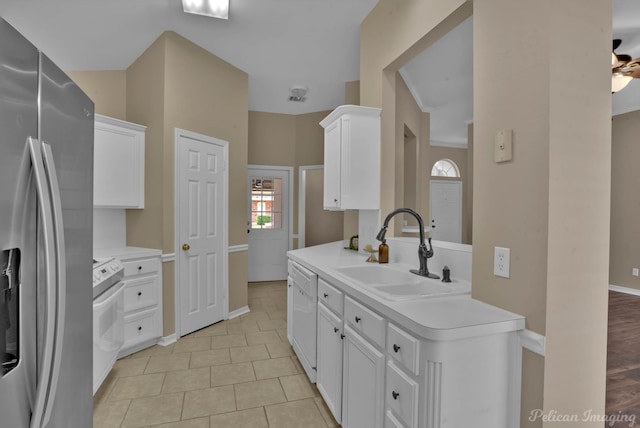 kitchen with white cabinetry, sink, light tile patterned floors, and white appliances