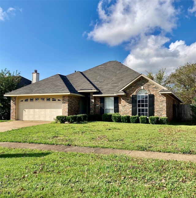 ranch-style home with a front yard and a garage