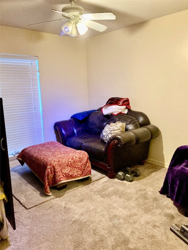 carpeted living room featuring ceiling fan