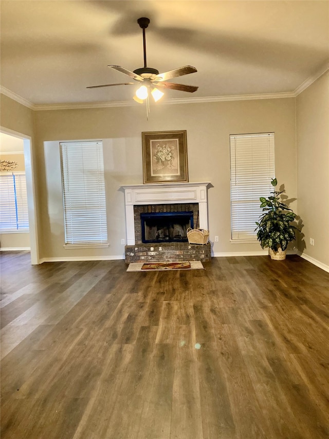 living room with a tile fireplace, dark wood-type flooring, ceiling fan, and ornamental molding