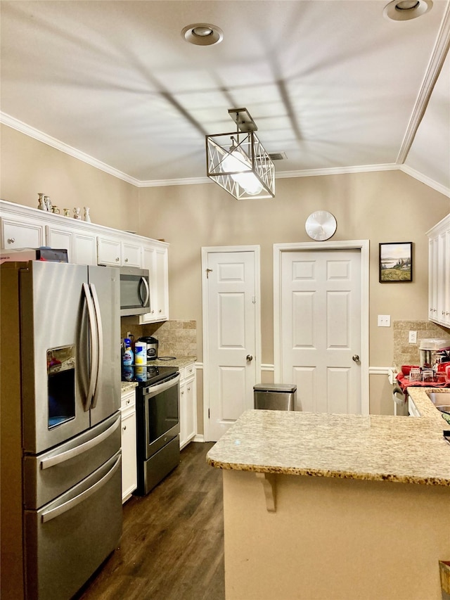 kitchen featuring appliances with stainless steel finishes, dark hardwood / wood-style flooring, decorative light fixtures, and white cabinetry