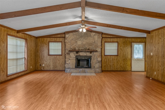 unfurnished living room featuring wood walls and light wood-type flooring