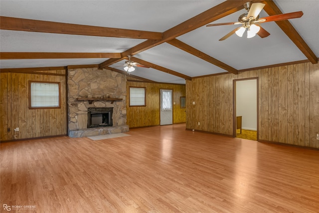 unfurnished living room featuring wooden walls and light wood-type flooring