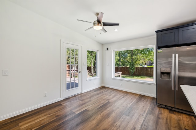 interior space with dark wood-type flooring, ceiling fan, and lofted ceiling