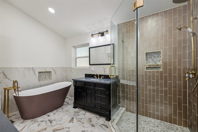 bathroom with vanity, tile walls, and independent shower and bath