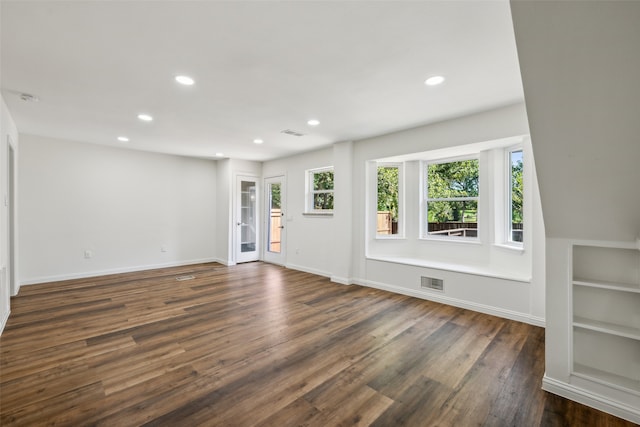 unfurnished living room featuring dark hardwood / wood-style flooring