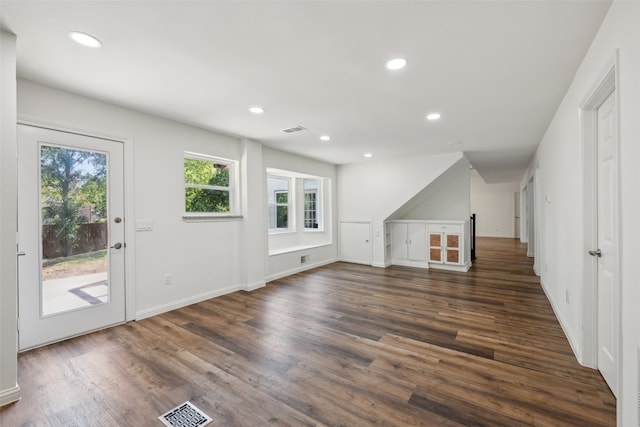 unfurnished living room featuring dark hardwood / wood-style flooring