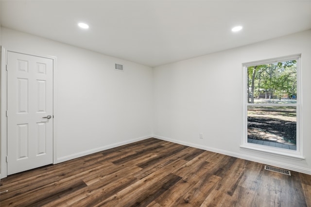 unfurnished room featuring dark hardwood / wood-style flooring