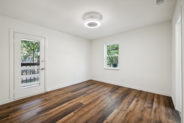 unfurnished room with dark hardwood / wood-style floors