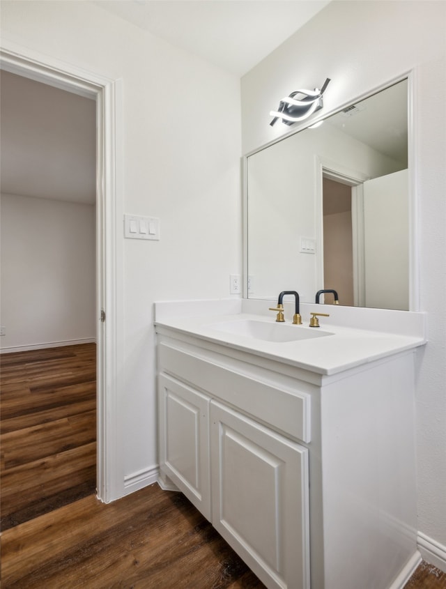 bathroom with vanity and wood-type flooring