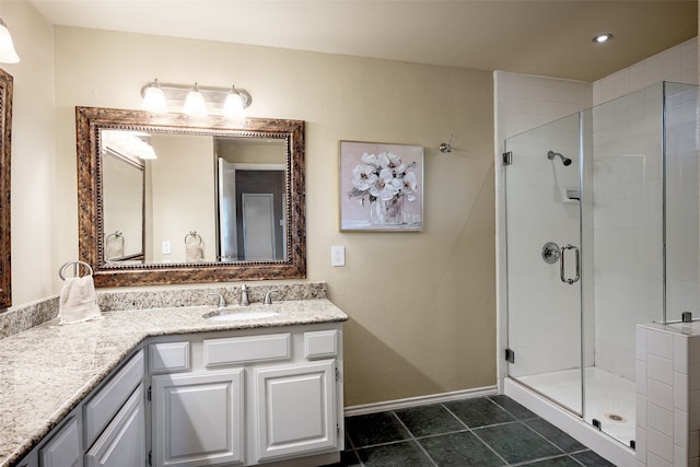 bathroom featuring vanity, a shower with shower door, and tile patterned floors