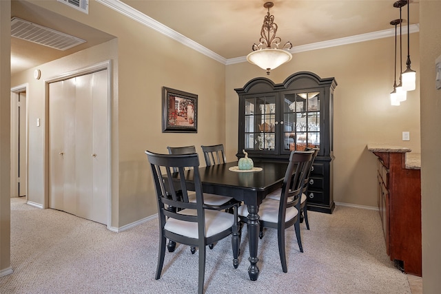 carpeted dining space with crown molding