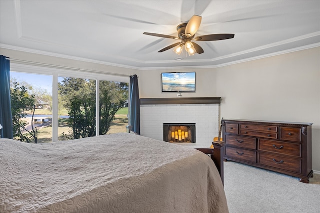 bedroom with ceiling fan, crown molding, a brick fireplace, and light colored carpet