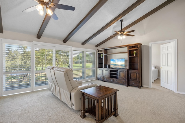 carpeted living room with vaulted ceiling with beams, a healthy amount of sunlight, and ceiling fan