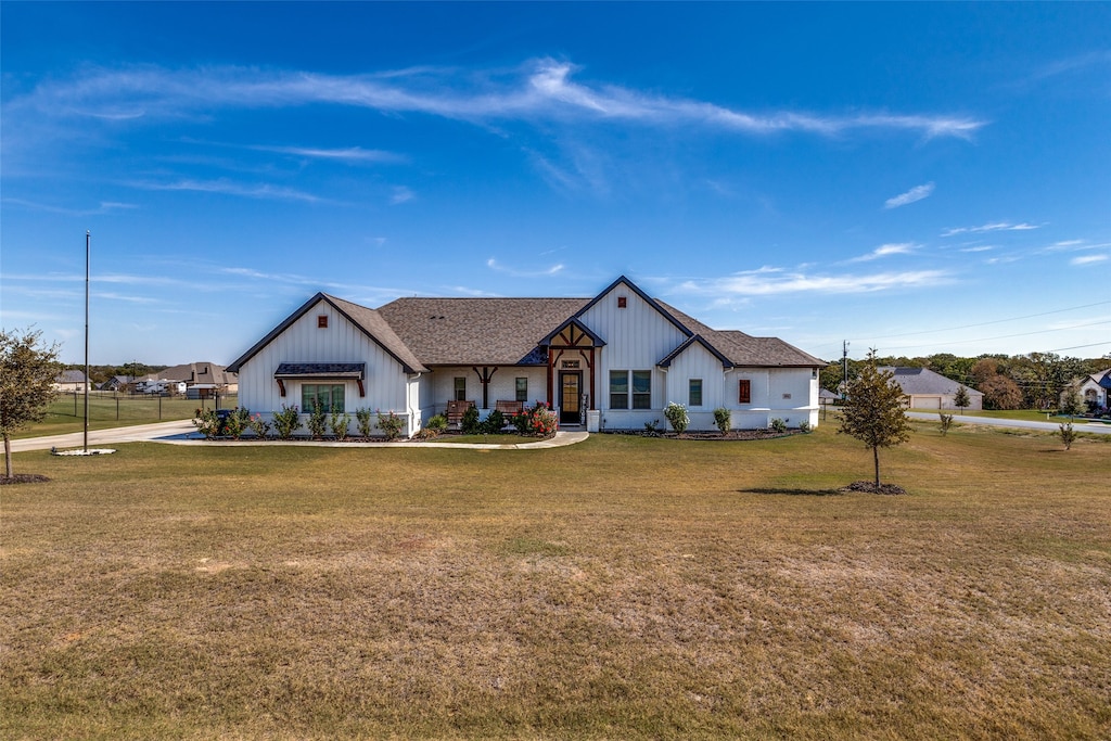 modern farmhouse style home with a front yard