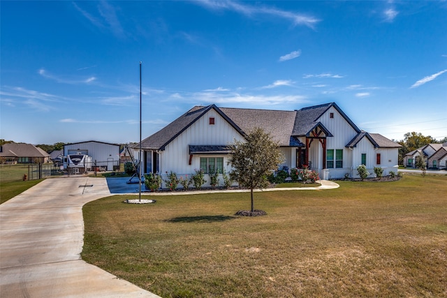 modern inspired farmhouse with a front lawn