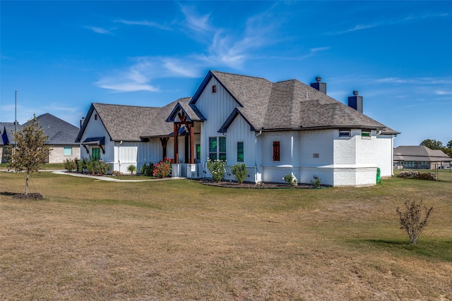 back of property with a yard and central AC