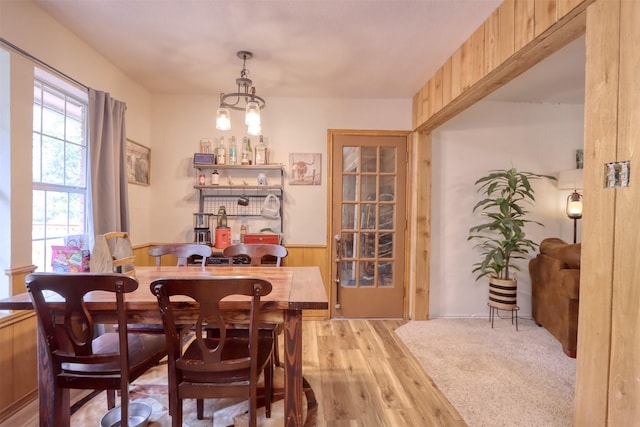 6495 Waterworks Rd, Midlothian, TX 76065 - dining space with a wainscoted wall, light wood-style floors, and wooden walls