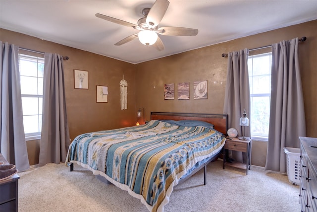 bedroom with light colored carpet and ceiling fan