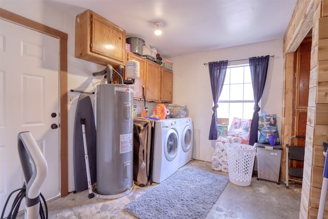 washroom featuring cabinets, electric water heater, and washer and clothes dryer