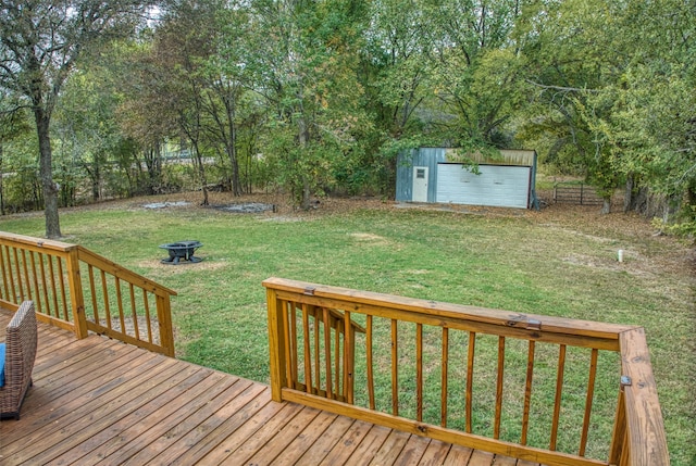 wooden deck featuring a storage unit, a yard, and a fire pit