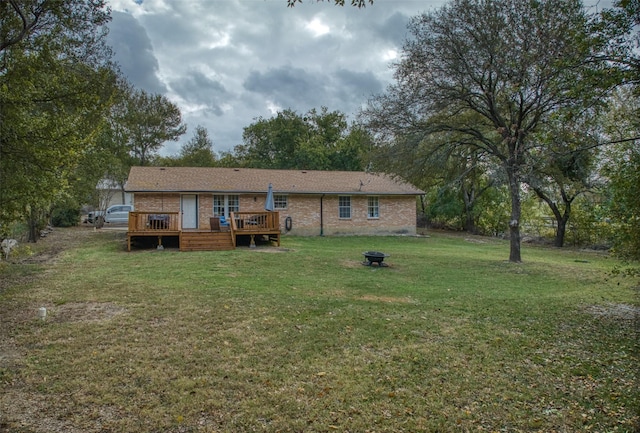 6495 Waterworks Rd, Midlothian, TX 76065 - back of property featuring a fire pit, brick siding, a deck, and a lawn