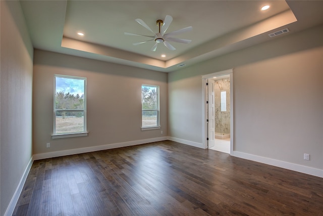 empty room with dark wood-type flooring, ceiling fan, and plenty of natural light