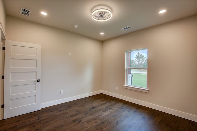 spare room featuring dark wood-type flooring