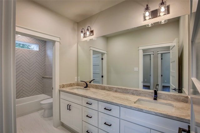 full bathroom featuring toilet, tiled shower / bath, and vanity