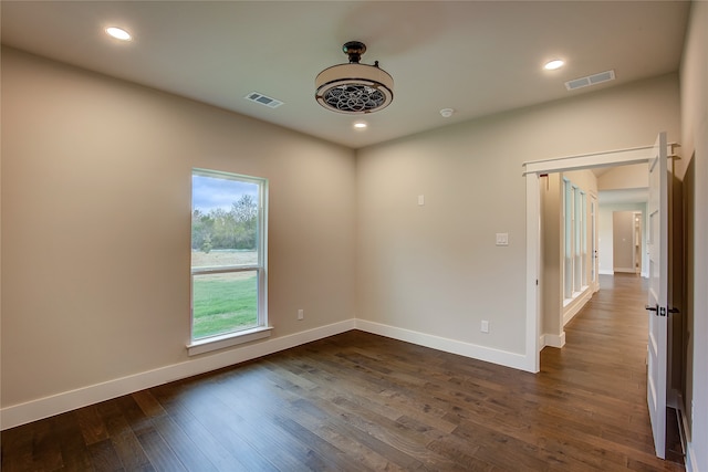 empty room with dark wood-type flooring