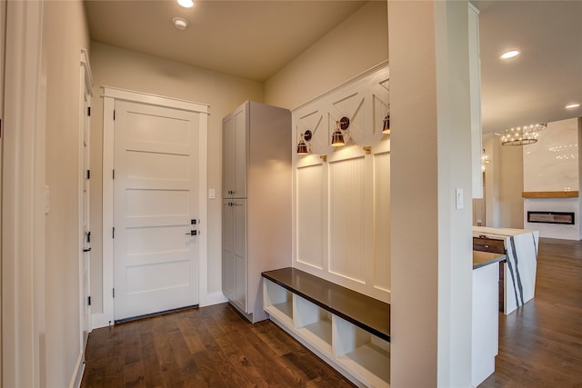 mudroom featuring an inviting chandelier and dark hardwood / wood-style floors