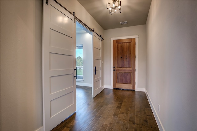 entryway featuring a barn door and dark hardwood / wood-style floors