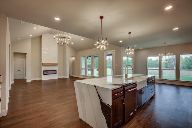 kitchen with lofted ceiling, sink, dark hardwood / wood-style floors, and a healthy amount of sunlight