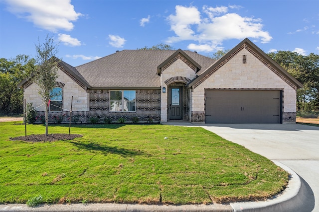 french country inspired facade featuring a garage and a front lawn