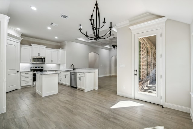 kitchen featuring white cabinetry, light hardwood / wood-style flooring, kitchen peninsula, ceiling fan with notable chandelier, and appliances with stainless steel finishes