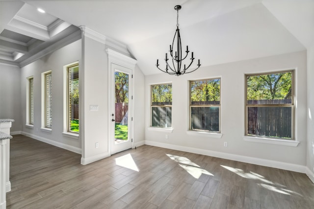 unfurnished dining area with a chandelier, hardwood / wood-style flooring, crown molding, and coffered ceiling