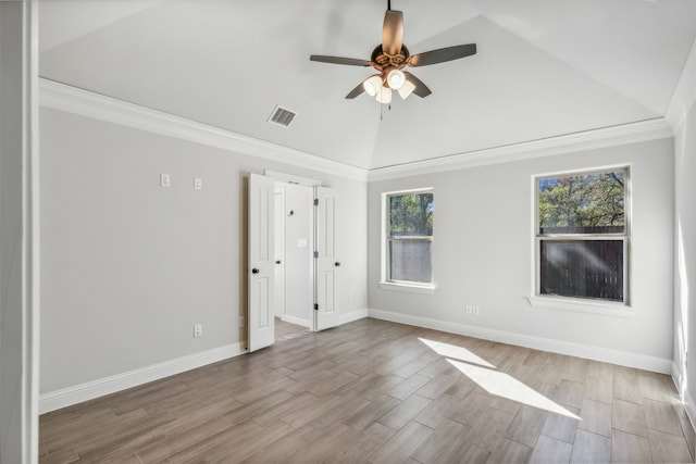 unfurnished bedroom featuring ceiling fan, lofted ceiling, crown molding, and light hardwood / wood-style flooring