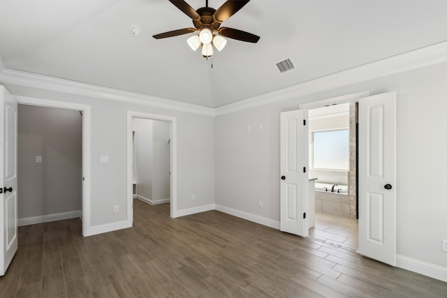 unfurnished bedroom featuring ceiling fan, dark hardwood / wood-style flooring, and ornamental molding