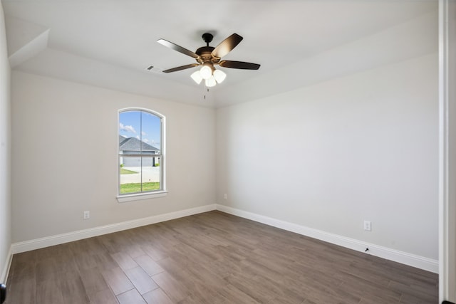 empty room featuring ceiling fan and dark wood-type flooring